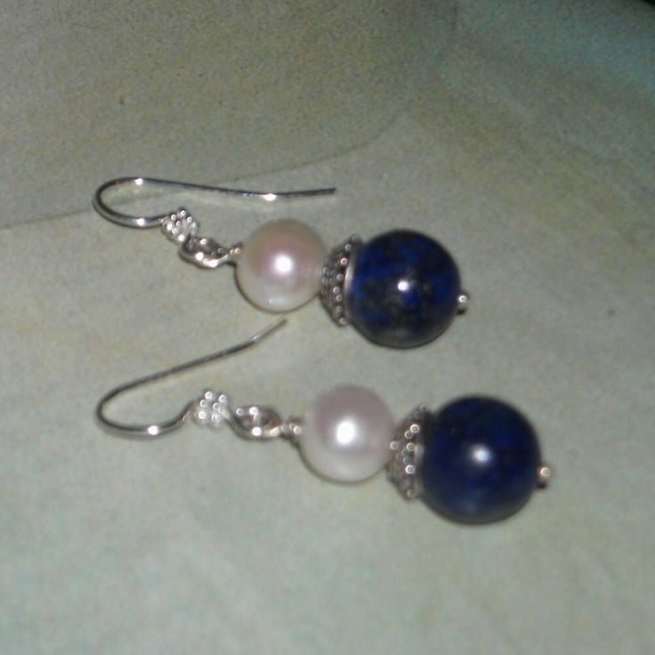 Lapis Lazuli Pearl Earrings Gorgeous 10 mm lapis lazuli beads, 10 mm freshwater pearls, Bali sterling silver bead caps securely wrapped on sterling ball headpins.  The earrings measure a dainty 1-5/8" from the top of the Bali sterling silver ear wires.   ** Matching bracelet available here: https://www.etsy.com/listing/252486083/lapis-lazuli-bracelet-pearl-bracelet * Lapis Lazuli is a deep blue crystal flecked with white and gold. It is a highly prized gemstone. * Lapis Lazuli is thought to stim Classic Round Lapis Lazuli Jewelry, Elegant Nickel-free Jewelry With Round Beads, Classic Blue Pearl Earrings For Wedding, Anniversary Jewelry With Matching Round Bead Earrings, Blue Round Pearl Earrings For Anniversary, Lapis Lazuli Dangle Jewelry As A Gift, Lapis Lazuli Dangle Jewelry For Gift, Formal Lapis Lazuli Jewelry With Round Beads, Blue Round Pearl Earrings For Wedding