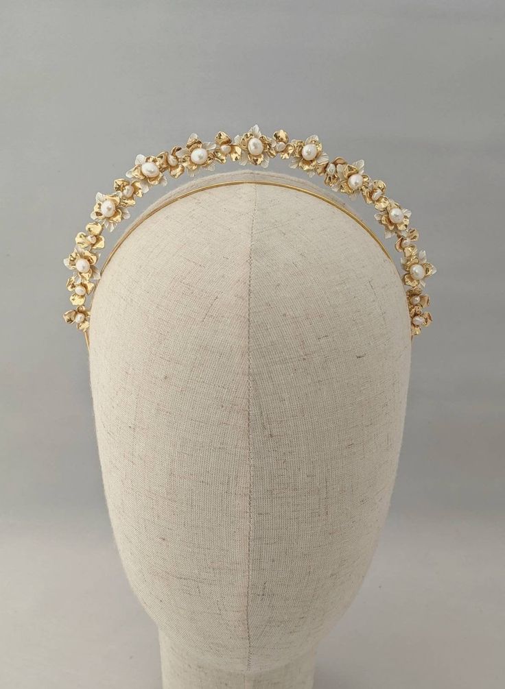 The Primrose Petite Halo Headband This romantic headband is handcrafted using an array of gold and white tone flower shapes, finished with freshwater pearls, creating a modern bridal feel. The headband sits 2cm above the head. The petite halo range is designed to be worn simply on their own, or paired up with another of our headbands. Please feel free to ask if you would like to see an example of how this can be paired with another headband. All of our items are handcrafted for each order so ple Pearl Wedding Headband, Pearl Tiara Wedding, Gold Bridal Crowns, Pearl Headband Wedding, Bridal Halo, Headband Gold, Pearl Bridal Headband, Pearl Headpiece, Bridal Headwear