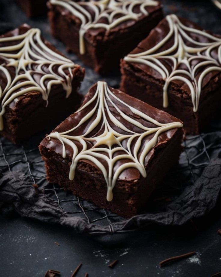 chocolate brownies with white icing on a cooling rack