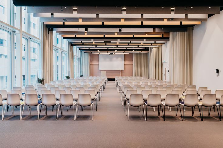 an empty conference room with rows of chairs