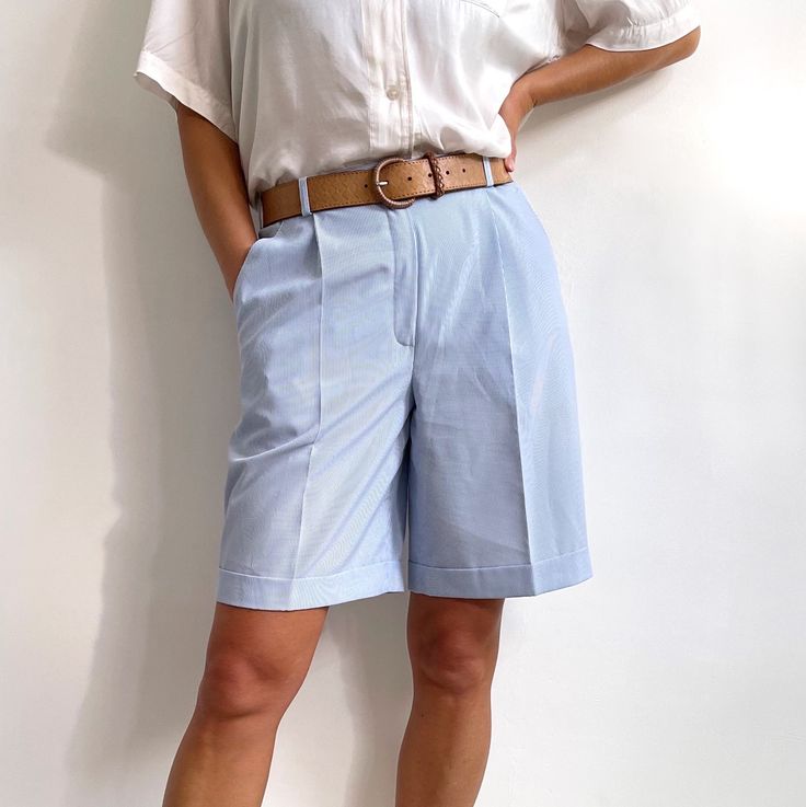 Classy, summery vintage ladies bermuda shorts in light blue and white skinny stripe. Really neat looking, knee long with neat pleats, belt loops, elasticated side panels, zip and button fly and pockets at the front. They are made from lightweight, breathable fabric with fine ribbed texture. Perfect for looking smart in the city or worn casualy with a T-shirt. Made by Canda, C&A. 100% polyester. Medium size, labelled as 14UK/40EUR. Morr of a present day UK 10-12.  Measurements when laid flat are: Vertical Stripes Bottoms For Summer Workwear, Classic Bermuda Shorts With Short Inseam For Summer, Summer Bottoms With Vertical Stripes In Short Length, Classic Spring Knee-length Shorts, Classic Summer Bermuda Shorts, Classic High-waisted Bermuda Shorts For Summer, Classic High-waisted Shorts For Spring, Classic Bermuda Shorts With Built-in Shorts For Summer, Classic Spring Shorts With Belt Loops