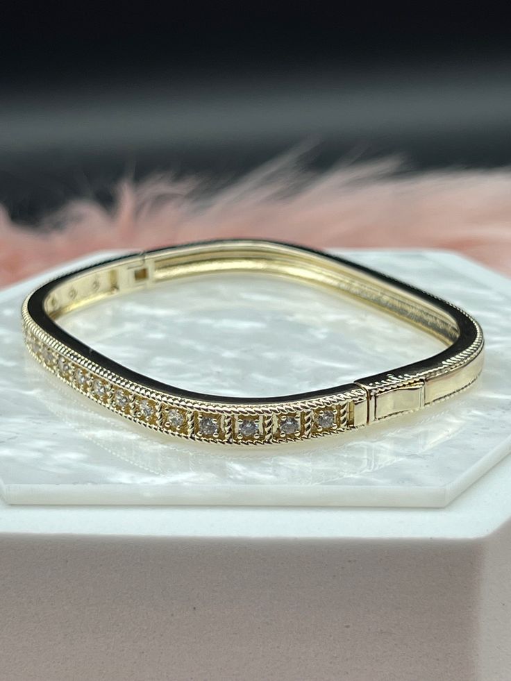 The CZ Diamond Square Bangle Bracelet is a contemporary and elegant accessory, featuring a sleek square-shaped design encrusted with dazzling cubic zirconia (CZ) diamonds. This sophisticated bracelet offers a modern twist on the classic bangle, making it a perfect blend of luxury and style. Size: 7 1/4 inches - Inner Diameter Material: Brass with 18K Gold Plating with Rhodium Coating Lead Free and Hypoallergenic Rectangular Diamond Accent Bracelet For Wedding, Wedding Diamond Bracelet With Rectangular Diamond Accents, Wedding Diamond Bracelet With Rectangular Accents, Rectangular Cubic Zirconia Bracelets, Elegant Stackable Diamond Bangle Bracelet, Elegant Stackable Gold Bracelet With Cz, Elegant Stackable Gold Bracelet With Cubic Zirconia, Elegant Stackable Cubic Zirconia Bangle, Elegant Cubic Zirconia Stackable Bangle