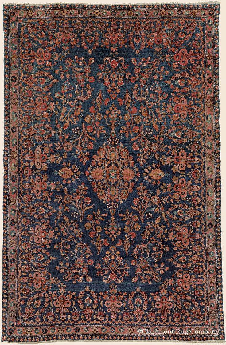 an antique rug with blue and red colors