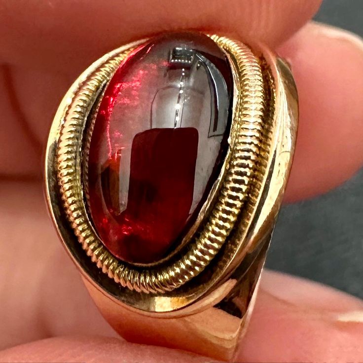 Here's a particularly appealing example of a late Georgian cabochon garnet ring. The garnet is deep and glows brightly from all angles. Its only embellishment is a rounded ridged border of rose gold, typical for this style.  The simple tapered rose gold band bears two inscriptions, "All that remains" under the bezel, and "Cath. Bunbury died 8 July 1799" along the exterior of the band.  The size is 5 1/2 or K 1/2 - and the inscription means the ring cannot be resized.  With only minimal thinning Victorian Cabochon Rings For Formal Occasions, Victorian Cabochon Rings For Formal Events, Antique Ruby Signet Ring For Formal Occasions, Vintage Oval Ruby Ring For Ceremonial Occasions, Vintage Oval Ruby Ring For Ceremonies, Vintage Open Ruby Ring For Formal Occasions, Formal Oval Ruby Ring, Victorian Domed Ring For Formal Occasions, Antique Style Round Ruby Rings