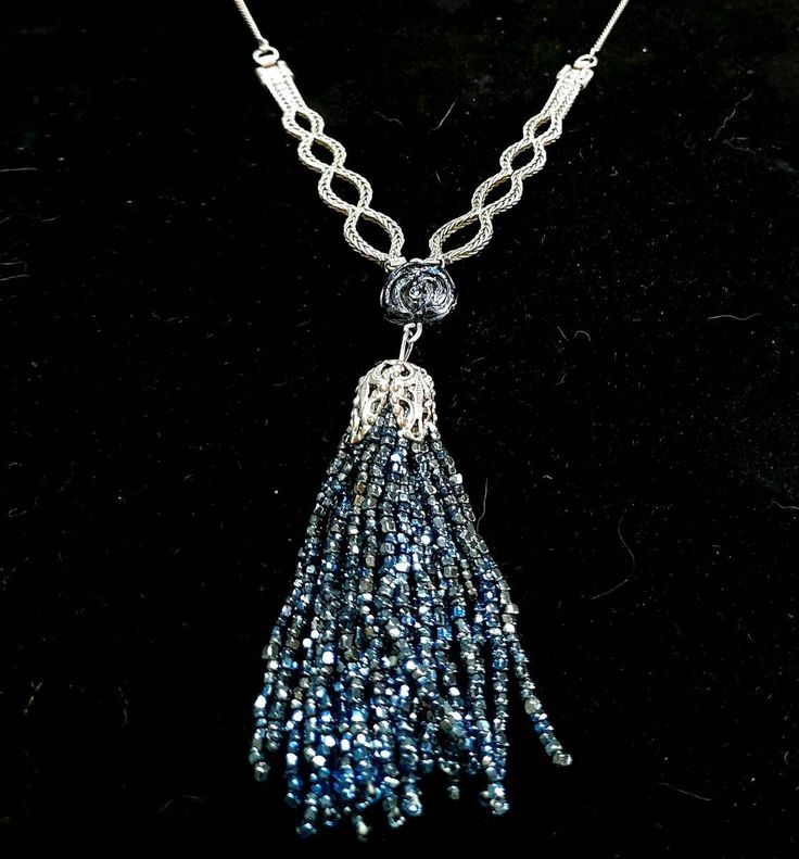 A striking dress jewellery vintage piece.  It's unusual, recycled and unique. The Tassel is tiny blue beads, fluid, sparkly and the chain, lovely in itself, i am informed is silver.  A very pretty ensemble.  Dimensions: Tassel - 8 cm long round  Chain and tassel total - 17.5 cm Blue Pendant Necklace For Evening, Silver Jewelry With Beaded Chain For Evening, Blue Beaded Evening Jewelry, Elegant Blue Beaded Necklaces With Chain, Blue Beaded Jewelry For Evening, Silver Beaded Chain Necklace For Evening, Handmade Blue Jewelry For Evening, Silver Beaded Chain Necklaces As Gift, Silver Beaded Necklaces With Dangling Beads For Gifts