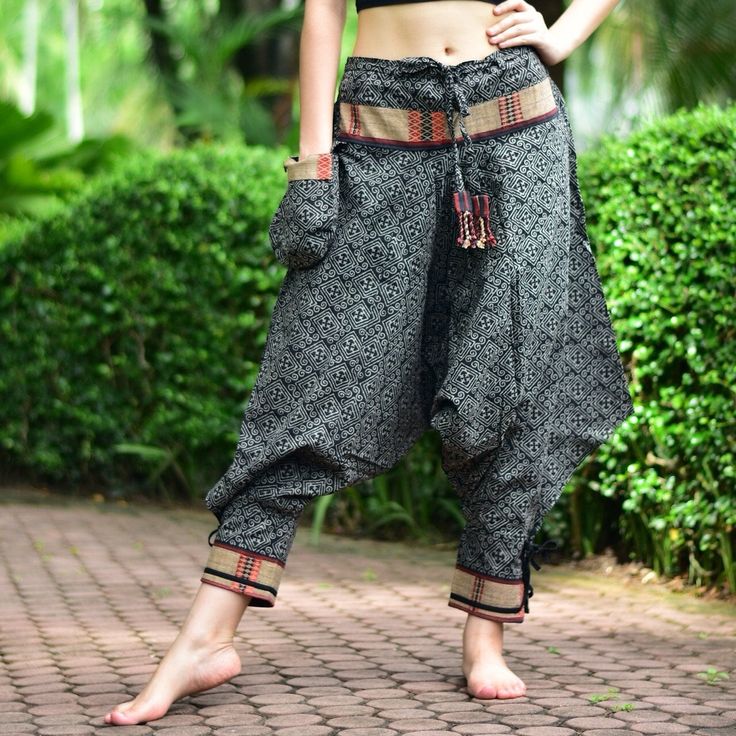 "Black Thai Traditional pattern pants, Hmong pants, Traditional Thai pants, Harem pants, Unisex pants Tribal pants is very comfortable and easy to wear, Unisex for Men and Women Every Detail of Tribal pants is made by Thai Craftsmanship. Tribal pants is inspired by Tribal in the North of Thailand or Hmong. Redesign for easy to wear and comfy. Great for many occasion activities like Chilling time, Casual wear, Relax time. This item is made of high-quality cotton in the north of Thailand. Printed Black Hippie Long Pants, Traditional Wide-leg Pants With Pockets, Traditional Wide Leg Pants With Pockets, Black Cotton Hippie Pants, Traditional Cotton Pants For Festivals, Traditional Long Pants Bottoms With Pockets, Traditional Wide Leg Harem Pants For Festivals, Harem Pants With Pockets For Festivals, Traditional Bottoms With Pockets In Long Pants Style