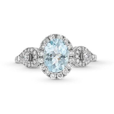 an oval cut aqua blue topazte and diamond engagement ring in 18k white gold