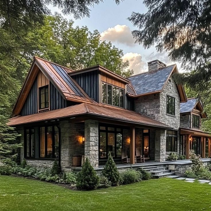 a large house with lots of windows on the front and side of it, surrounded by trees