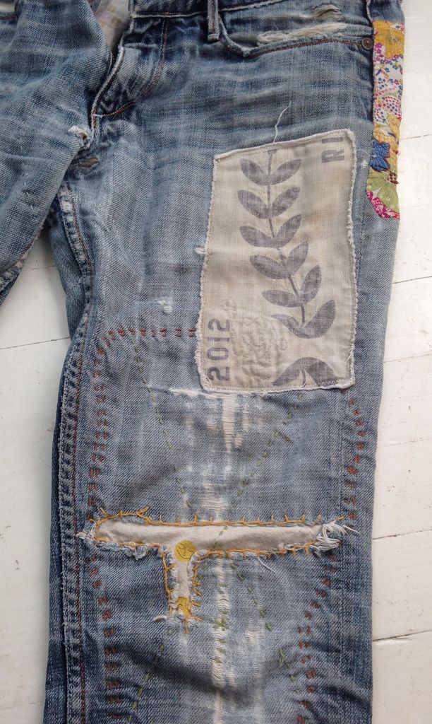 an old pair of jeans with some patches on them