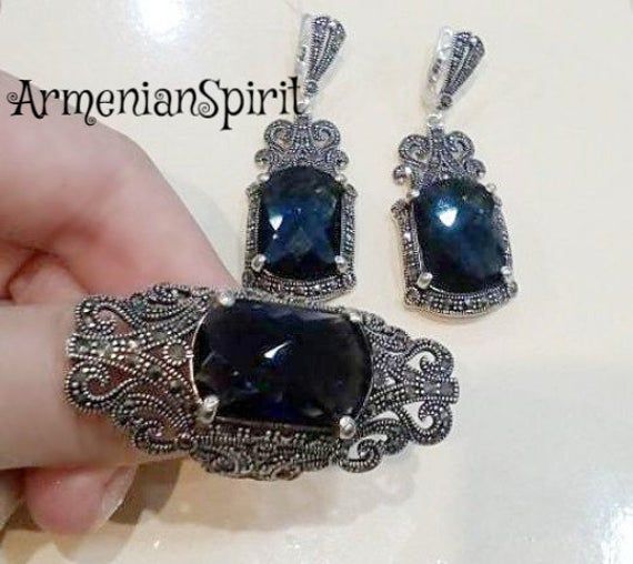 Navy blue SET silver marcasite jewelry armenian handmade very big ring very long earrings with blue stone Royal jewelry wedding dark blueYou can buy ring and earrings separately and in a set.In a set it will be cheaper.WE MAKE THIS SET IN ANY COLOR (stone): RED, BLUE, BLACK, BROWN, etc.RING:Weight: 11.8 gramsEARRINGS:The weight is approx. 14.6 gramsThe length approx.: 5 cm = 2 inchThe stone is lab topaz.Shipping time:Europe 3 weeks.USA and other countries 3 weeksI don`t accept returns and  excha Traditional Silver Jewelry For Evening, Handmade Elegant Sapphire Jewelry, Antique Hand Set Silver Jewelry, Evening Jewelry With Oxidized Silver Finish, Elegant Oxidized Jewelry For Parties, Elegant Oxidized Finish Jewelry For Parties, Silver Jewelry With Oxidized Finish For Evening, Elegant Pendant Earrings With Stone Setting, Formal Sapphire Jewelry In Metal