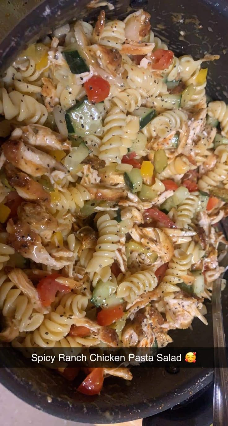 a skillet filled with pasta and vegetables