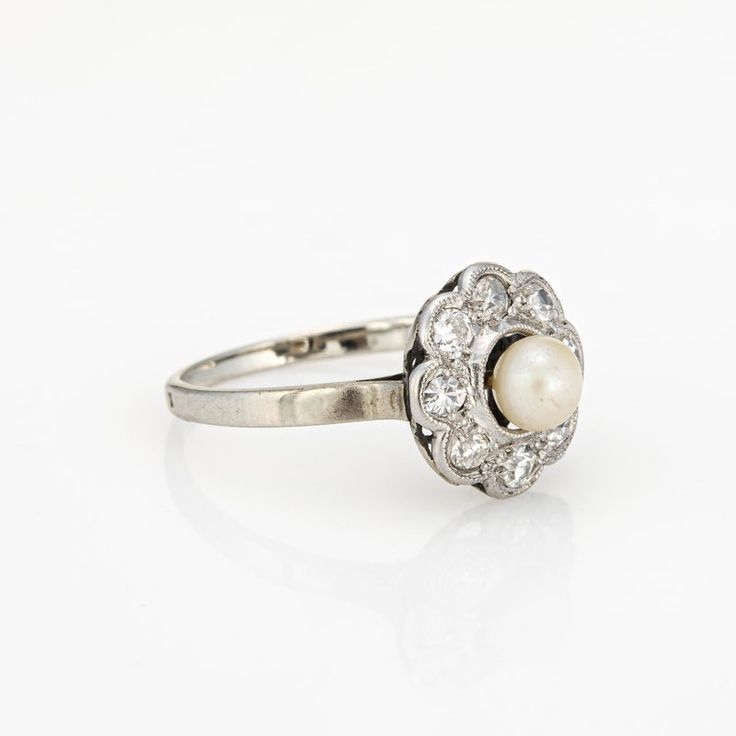 This is part of Chairish’s Fine Jewelry assortment.  Stylish antique Edwardian pearl & diamond cluster ring crafted in platinum topped 18k white gold (circa 1900s to 1910s). One center set pearl measures 5mm, accented with eight estimated 0.06 carat old single cut diamonds. The total diamond weight is estimated at 0.48 carats (estimated at H-I and SI1-I2 clarity).    The classic cluster design highlights a halo of diamonds surrounding the creamy center set pearl. The ring is great for wear as an Elegant White Gold Pearl Ring With Rose Cut Diamonds, Vintage Pearl Ring With Brilliant Cut For Formal Occasions, Oval Platinum Pearl Wedding Ring, Classic White Gold Pearl Ring In Platinum, Heirloom White Gold Pearl Ring With Rose Cut Diamonds, Platinum Pearl Wedding Ring, Platinum Pearl Ring With Round Cut For Wedding, Platinum Pearl Ring For Wedding, Victorian White Gold Cluster Ring For Wedding