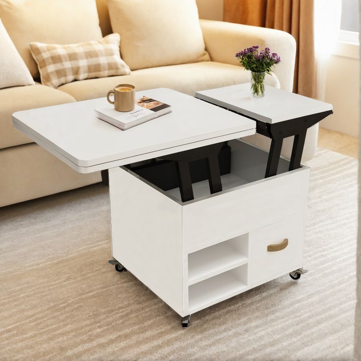 a living room with a couch, coffee table and book shelf on wheels in it