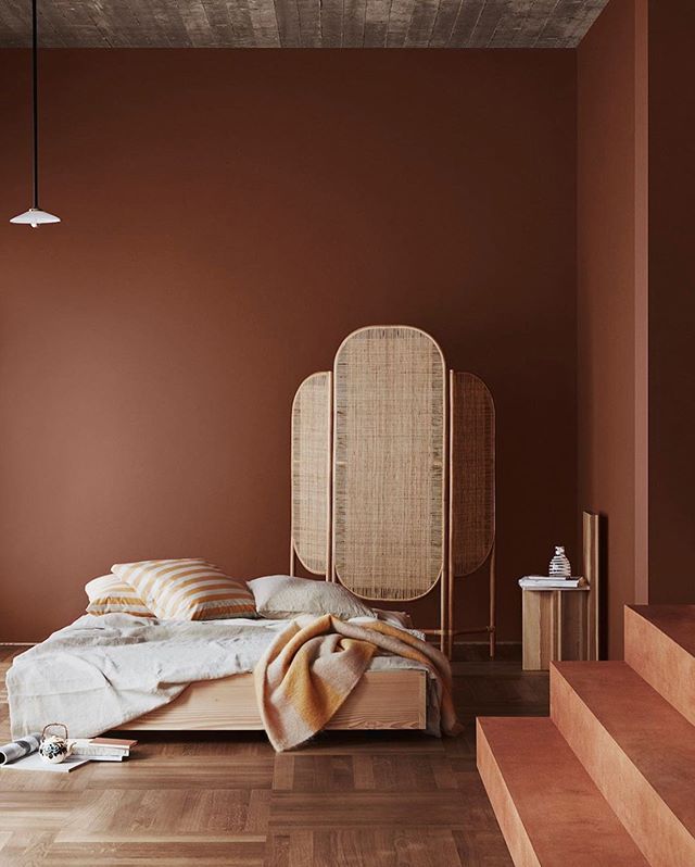 a bed sitting on top of a hard wood floor next to a wooden stair case