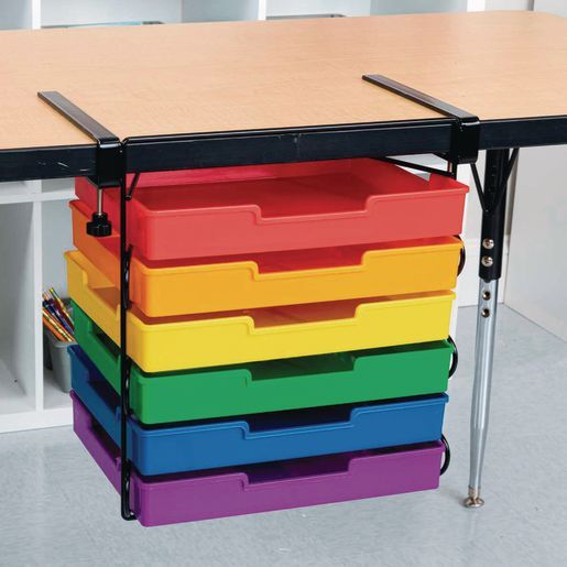 a multicolored plastic drawer on the back of a school desk