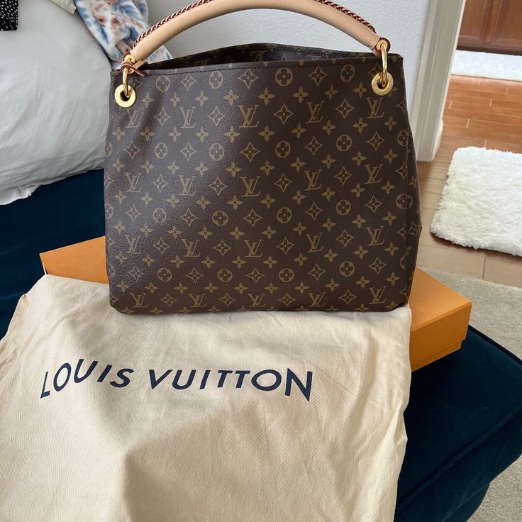 Brand New Never Used Louis Vuitton Arty Mm Monogram Canvas Key Ring Sleek Braided Handle Interior Zip Large Pocket Interior Pockets Both Sides L 16.75 H 11.75 W 7.25 Drop 3 In Bag Is In Mint Unused Condition Comes With Dustbag And Original Box Never Used Will Ship In Original Box - With Dustbag Designer Monogram Canvas Bags, Artsy Louis Vuitton, Loop Hobo Louis Vuitton, Lv Loop Hobo Bag, Authentic Louis Vuitton Bags, Louis Vuitton Handbags Classic Monogram Canvas Lv Bags, Louis Vuitton Brown Bag, Louis Vuitton Artsy Mm, Louis Vuitton Artsy