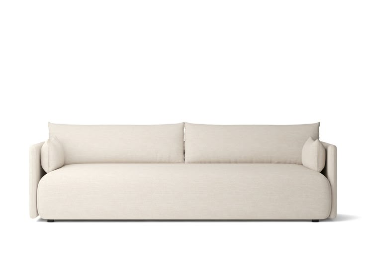 a white couch with two pillows on it