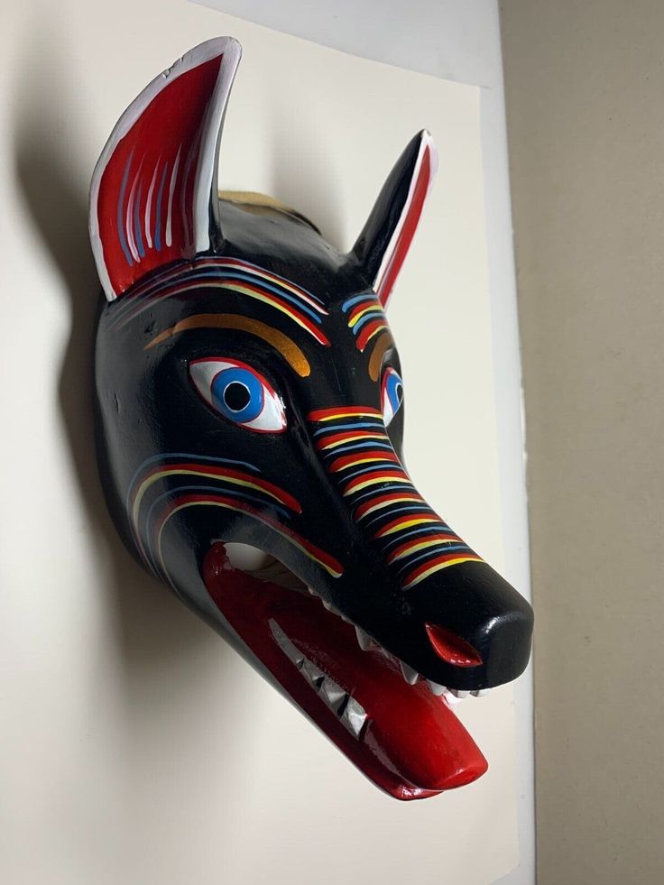 an animal mask is hanging on the wall