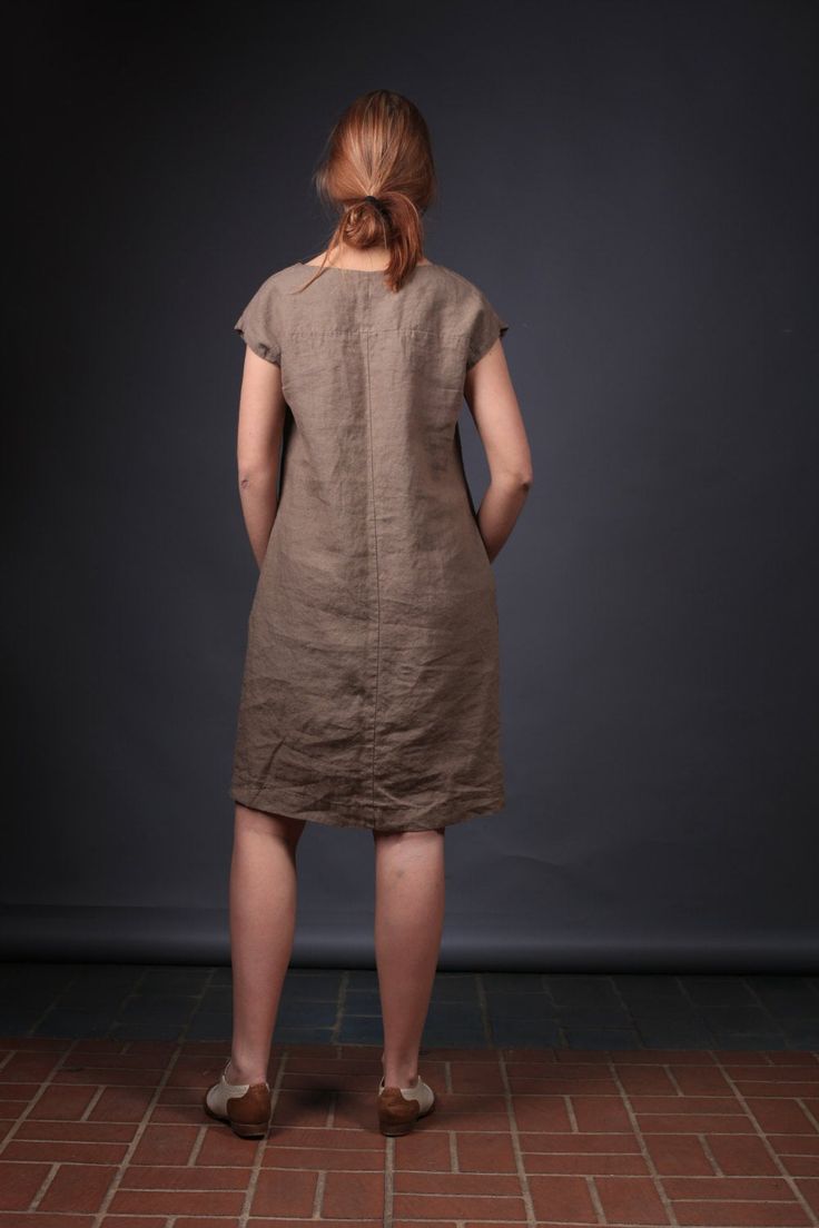 "Handcrafted Oeko-Tex Standard certified 100% European linen smock dress ideal for everyday wear. Perfect for springtime or chilly summer days. Always dress to kill! Neckline: round Silhouette: A-line Length: ±39\"/100cm (we can make adjustments) Sleeve length: cap Pockets: side seam Details: *Medium weight *Model is wearing size M *Maternity-friendly *Relaxed fit *Not-ironed (and no need to) *Handmade by @LinenCloud Easy care: - Machine wash gentle - Wash seperately or with similar colours - Tu Casual Brown Linen Dress With Relaxed Fit, Fitted Linen Tunic For Summer, Brown Linen Dress For The Beach, Casual Knee-length Shift Linen Dress, Casual Knee-length Linen Shift Dress, Casual Brown Linen Midi Dress, Casual Linen Dresses For Daywear, Casual Linen Day Dresses, Casual Linen Shift Midi Dress