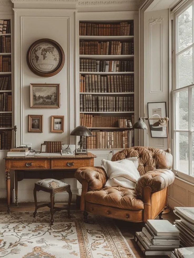 a room with a chair, desk and bookshelf filled with lots of books