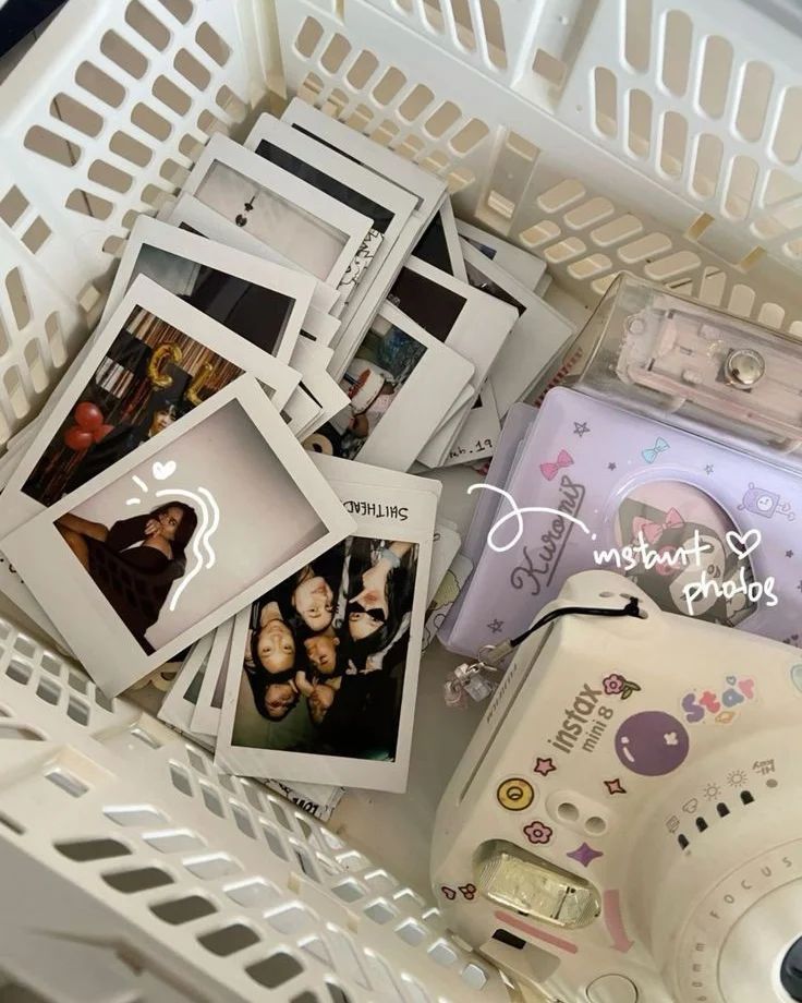 several polaroid frames are stacked on top of each other in a white plastic basket