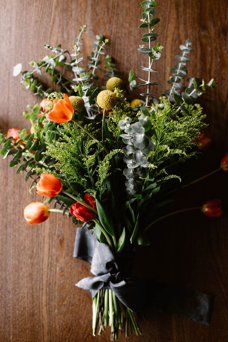 a bouquet of flowers on a wooden table