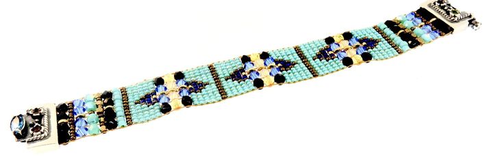 CHILI ROSE Blue Desert Cowboy Gemstone Bracelet Adonnah Langer hand looms Czech and Japanese seed beads with Czech fire-polished and brass beads woven into spectacular intricate designs Gorgeous Southwest pattern with stunning combination of Blue, Turquoise , Jet and a hint of Cornflower Perfect accent for Jeans & Tee! The end caps and clasp are all set sterling silver .925 with gemstones of Garnet-Citrine-Blue Topaz (All of which may be customized) -Bracelet measures as shown 6 3/4 inch end Artisan Handwoven Rectangular Jewelry, Traditional Blue Handwoven Beaded Bracelets, Artisan Blue Jewelry With Bead Caps, Traditional Blue Jewelry With Bead Caps, Blue Handwoven Bracelet, Traditional Blue Bracelets With Spacer Beads, Artisan Blue Handwoven Beaded Bracelets, Desert Cowboy, Chili Rose