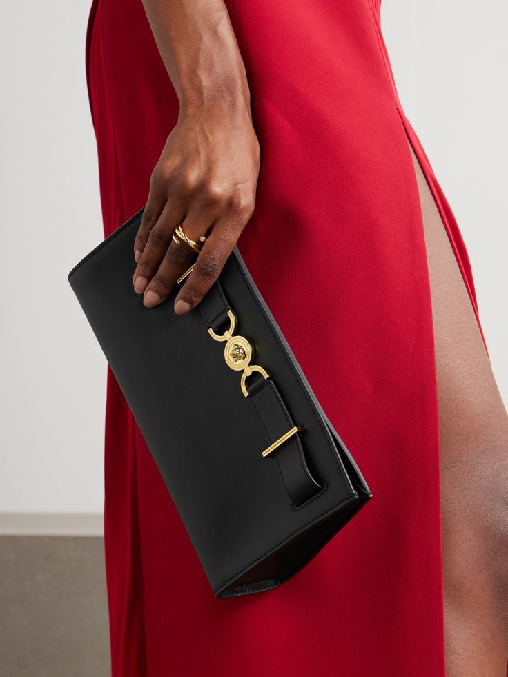 Versace’s sleek clutch is simply detailed with recognizable 'Medusa '95’ hardware. It’s crafted from leather and has a detachable chain strap so you can carry it crossbody, too. Stow smaller essentials inside, like your phone, wallet and keys. Classic Clutch With Palladium Hardware, Leather Clutch With Chain Strap For Night Out, Elegant Formal Clutch With Metal Hardware, Chic Black Clutch With Palladium Hardware, Classic Evening Clutch With Palladium Hardware, Elegant Leather Clutch With Palladium Hardware, Designer Clutch With Gold-tone Hardware For Events, Clutch Evening Bag With Metal Hardware, Evening Clutch With Metal Hardware