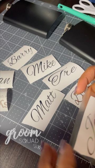 someone cutting up some paper with scissors on top of a table next to a pair of scissors