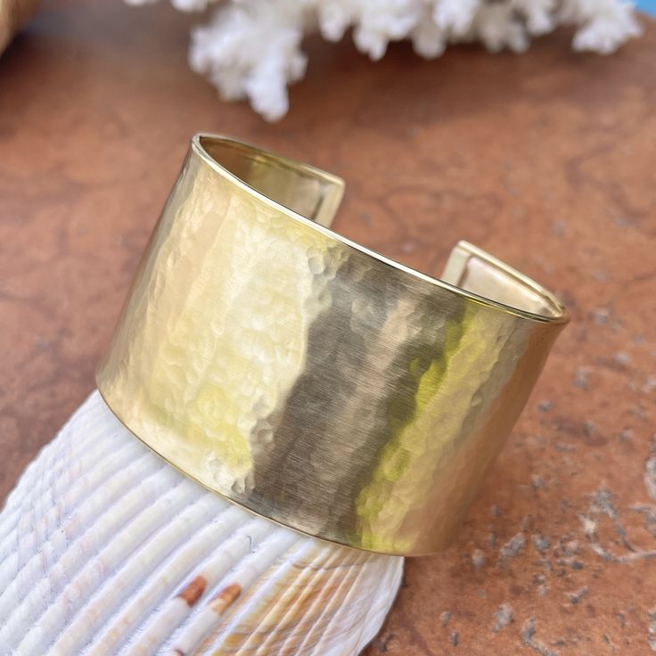 14KT polished yellow gold hammered + textured cuff bangle bracelet. Substantial and well made gold bangle that instantly brings a statement to the wrist. Lovely worn on its own or layered with more bangles. Width: 37mm Weight: 37.5g 585/ 14KT purity Adjustable; fits small to large wrists Shown on a 6" wrist Open cuff; simply slide over wrist Made in USA Modern Bangle, Hammered Cuff Bracelet, Saint Jewelry, Wide Cuff Bracelets, Cuff Bangle Bracelet, Gold Bangle, Wide Cuff, Statement Bracelet, Fabric Ribbon