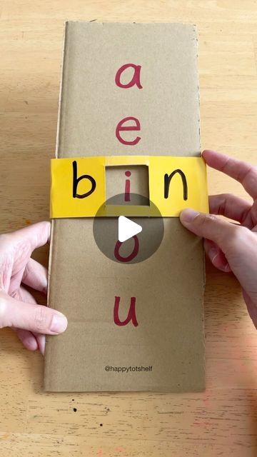 two hands holding up a book with the word ben u on it and an ad taped to its cover