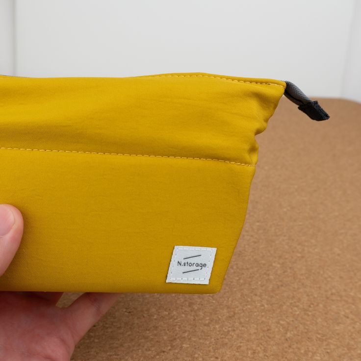 The Kokuyo N-Storage features a zipper closure that when open, rolls back allowing you to see all of its contents. Each pocket is at a diagonal keeping things easy to find and accesible. This pencil case has a medium holding capacity. The interior of the pencil case has a square deep pocket which can hold up to 13 pens. There is a shallow diagonal pocket perfect for holding an eraser, correction tape, or other small tool. Then finally there is a deep long rectangular pocket, perfect for holding Functional Rectangular Pencil Case, Travel Zipper Pencil Case In Rectangular Shape, Functional Rectangular Zipper Pouch Organizer, Travel Zipper Pouch Pencil Case, Functional Rectangular Organizer With Zipper Pouch, Multifunctional Pencil Case With Zipper For Daily Use, Functional Pencil Case With Zipper Pocket For Storage, Functional Pencil Case With Zipper Closure, Portable Rectangular Functional Pencil Case