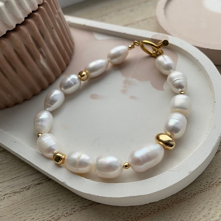 Handcrafted with an artisan's passion, with a unique design, this bracelet exudes an aura of sophistication that defies time. The pearls, gracefully strung together, encircle your wrist like a celestial dance, embracing you in an aura of opulence and grace. Cherish and Care: Like a precious work of art, these pearls demand tender care. Keep them away from harsh elements, allowing them to shine brightly for generations to come. A gentle caress with a soft cloth is all they need to maintain their radiant allure MEASUREMENTS: Choose a length for your pearl bracelet. Measure the length of your wrist with a measuring tape or you can use any thread and after apply the measurements to a regular ruler.  If you have any questions about your size or materials  be free to text me a message. Baroque Pearl Bracelets For Wedding, Baroque Pearl Wedding Bracelets, Beaded Baroque Pearl Bracelet, Baroque Pearl Beaded Bracelets For Wedding, Polished Beads Bracelet For Wedding, Gold Baroque Pearl Bracelets For Wedding, Handmade Classic Wedding Bracelets, Classic Handmade Wedding Bracelets, Handmade Baroque Pearl Bracelets With Round Beads