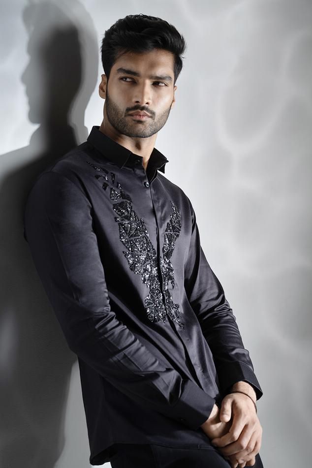 Black cotton shirt with black cutdana hand embroidered eagle.
Components: 1
Pattern: Hand embroidered
Type Of Work: Cutdana
Neckline: Collar
Sleeve Type: Full
Fabric: Cotton
Color: Black
Other Details: 
Note : Pant worn by the model is not for sale.
Occasion: Party - Aza Fashions Black Cotton Top With Chikankari Embroidery, Traditional Embroidered Shirt For Formal Occasions, Formal Festive Embroidered Shirt, Designer Embroidered Tops For Formal Occasions, Festive Formal Embroidered Shirt, Designer Long Sleeve Festive Shirt, Elegant Embroidered Shirt For Festive Occasions, Elegant Festive Embroidered Shirt, Traditional Black Shirt With Floral Embroidery