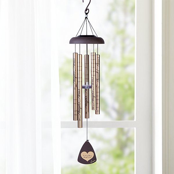 a wind chime hanging from the side of a window