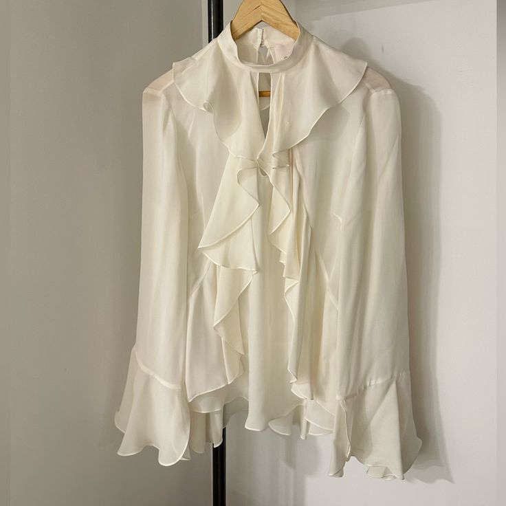 Cinq A Sept Nwt Ruffled Ivory Blouse Bought In Nyc. Never Worn, Great Condition Other Than Minor Snag In The Back Ruffle Pictured. Spring White Blouse With Ruffle Hem, White Spring Blouse With Ruffle Hem, White Ruffle Hem Blouse For Spring, White Ruffled Blouse For Office, White Blouse With Ruffle Hem For Spring, White Long Sleeve Tops With Ruffle Hem, Feminine Off-white Party Top, Elegant Ruffle Hem Tops For Work, White Feminine Top With Ruffle Hem