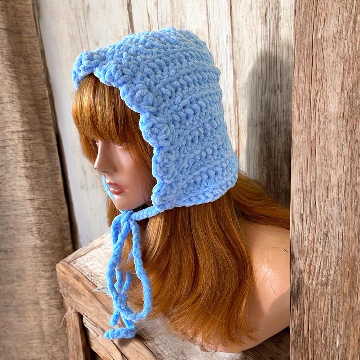 Embrace cozy elegance with our Fluffy Adult Bonnet, perfect for chilly days and winter wonderlands.  Handcrafted with care, each bonnet features a plush texture and bow tie detail, adding a touch of whimsy to your winter ensemble.  Whether you're hitting the slopes or strolling through a snow-kissed landscape, our bonnets double as both a stylish accessory and a snug earwarmer.  Treat yourself or gift a loved one with this delightful blend of warmth and charm. Washable for easy care.  It is best Adjustable Warm Bonnet, Adjustable Warm Solid Color Bonnet, Winter Bonnet With Ear Flaps, One Size Fits Most, Cozy Adjustable Bonnet With Beanie Shape, Adjustable Cozy Beanie Bonnet, Cozy Adjustable Beanie Bonnet, Warm Bonnet With Ear Flaps, Adjustable Cozy Cap Bonnet, Hand Knitted Brimmed Bonnet For Winter