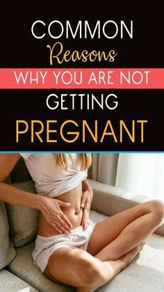 a woman sitting on top of a couch holding her stomach with the words common reason why you are not getting pregnant