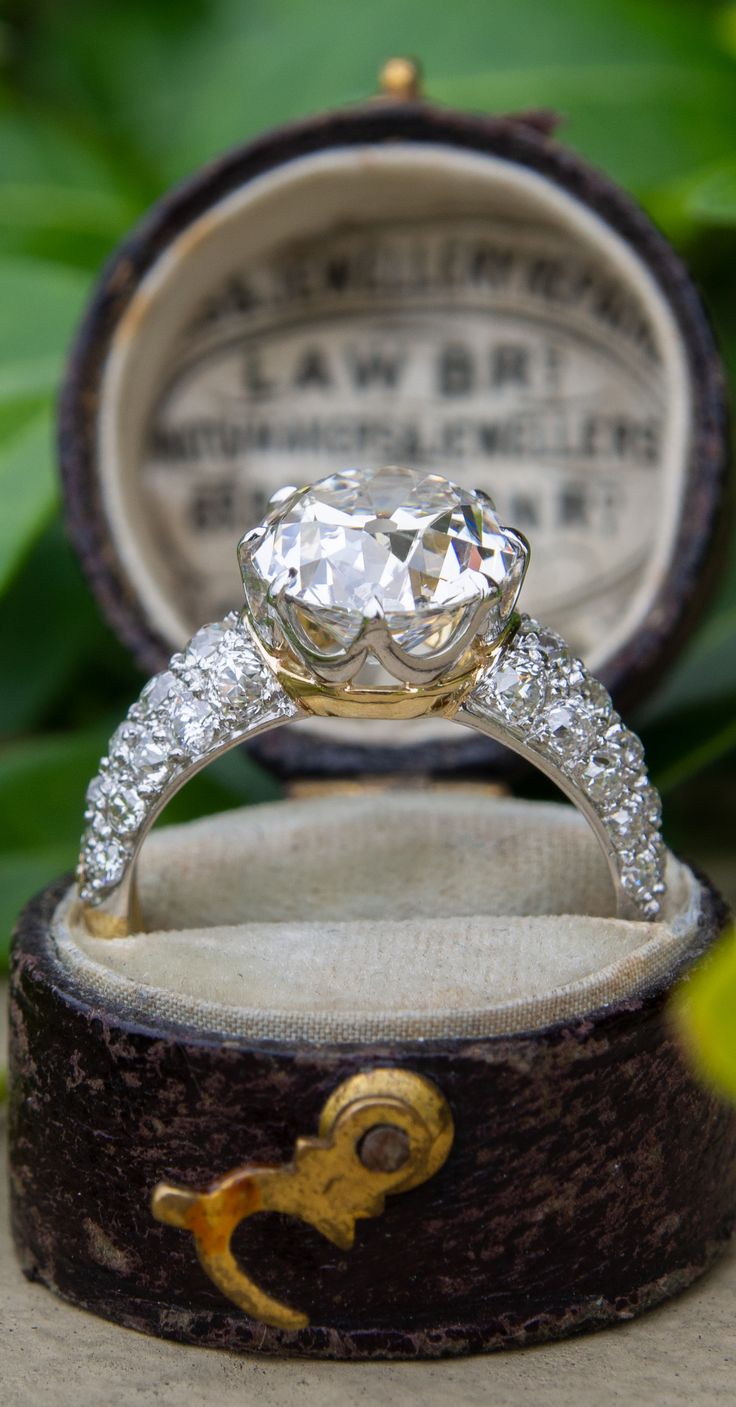 an old diamond ring is sitting in a box