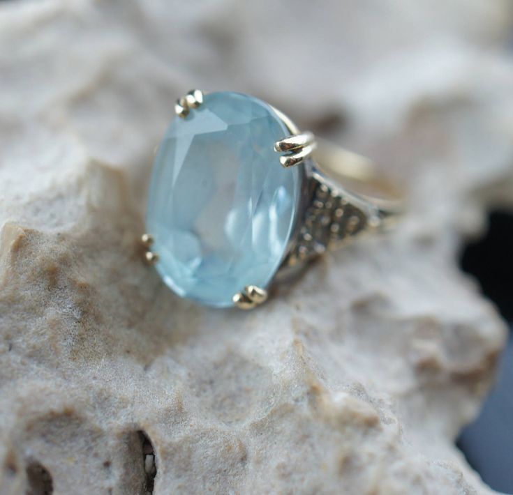 This is the perfect option for those who like cool, unique jewelry and the luxury, shine of yellow gold. This ring is well made, cute and/or elegant in design, and very desirable. Vintage ring decorated with the aquamarine like stone in the center and from the side is decorated with little diamonds . The 3 diamonds are missing. This ring stands out by itself or it is beautiful stacked with others rings. ♥ Age/era: 1980s - 1990s. ♥ The ring is a hallmark. 14K F.M. Franklin Mint. ♥ The ring's size Aquamarine Jewelry With Diamond Accents For Gift, Fine Jewelry For Anniversary In Light Blue, Gift Jewelry With Diamond Accents And Aquamarine, Gift Aquamarine Jewelry With Diamond Accents, Blue Oval Jewelry Stamped 14k, Light Blue Diamond Jewelry With Accent Stones, Blue 14k Stamped Ring Jewelry, Fine Jewelry In Light Blue Color, Fine Jewelry In Light Blue