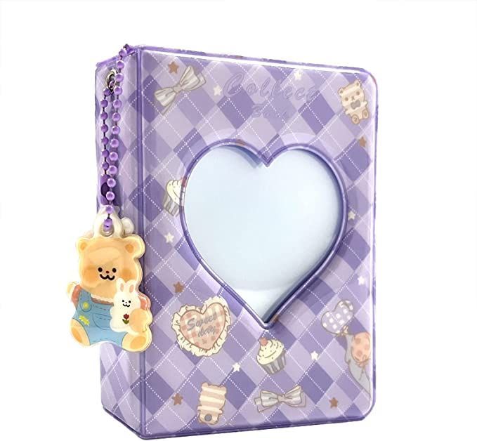 a purple case with a teddy bear hanging from it's side and a heart shaped mirror in the middle