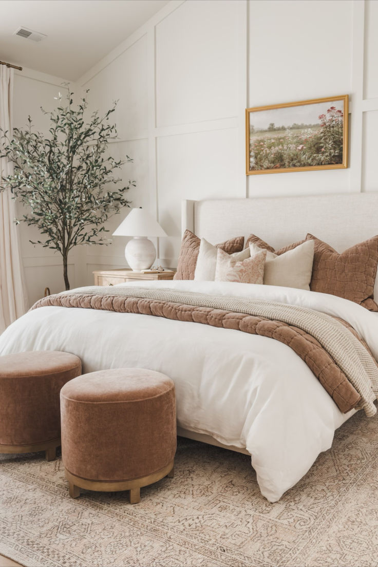 a large bed sitting in a bedroom next to a window