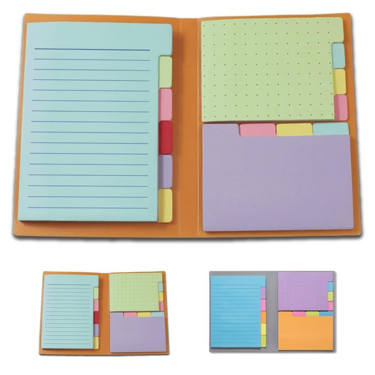 an open notebook with sticky notes and colored paper on the pages, isolated against a white background