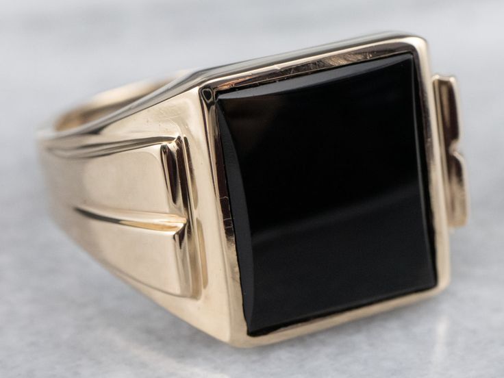 This vintage men's ring is stylish black onyx and yellow gold, a combination that is sophisticated and traditional. The design of this ring offers a little more size and substance but is still easy to wear. It sits flush to the hand and will be a great style piece for any man!Metal: 10K Yellow GoldGem: Black OnyxGem Measurements: 14.0 x 11.7 mm, RectangleRing Size: 12.50Marks: "10K B&F" Stamped on the inside band Timeless Onyx Signet Ring With Polished Finish, Classic Onyx Signet Ring With Polished Finish, Timeless Black Enamel Signet Ring For Formal Occasions, Classic Black Rings With Polished Edges, Classic Black Enamel Signet Ring, Formal Black Rings With Polished Edges, Timeless Black Rings With Polished Finish, Classic Black Onyx Signet Ring, Classic Onyx Signet Ring With Black Enamel