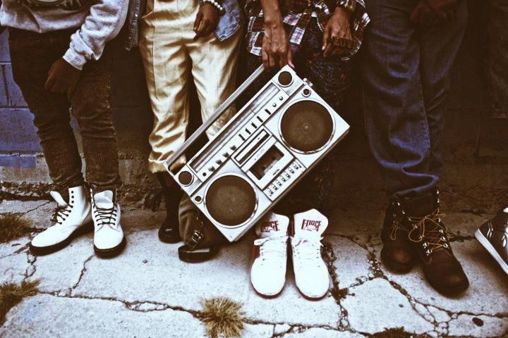 a group of people standing next to each other with speakers on their feet and shoes