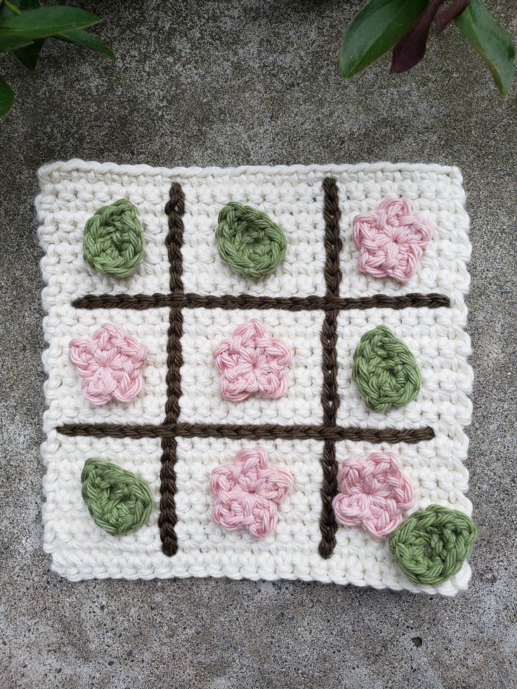 a crocheted board with flowers on it