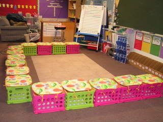 a classroom with lots of different colored boxes on the floor