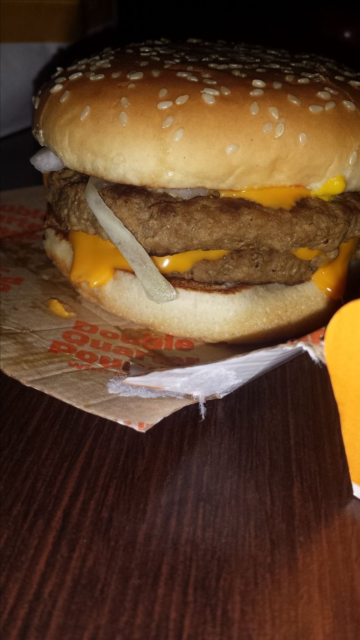 a hamburger sitting on top of a wooden table