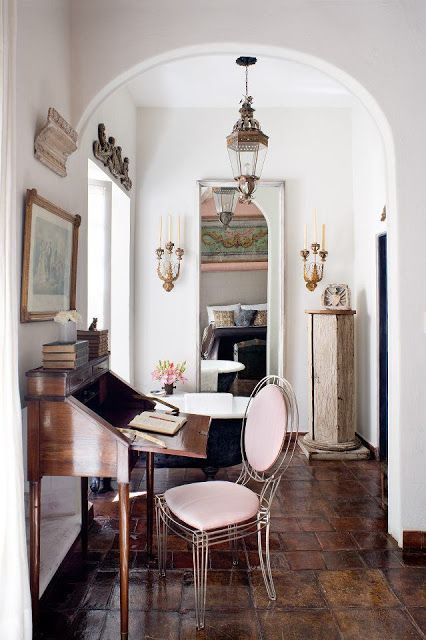 a room with a table, chair and piano in it