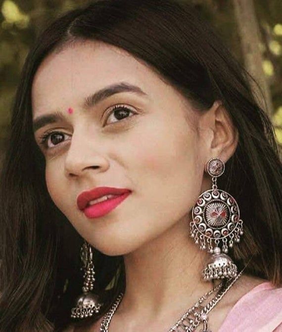 Add charm and charisma to your beautiful personality with these exquisitely handcrafted Afghani earrings jhumkas made with high quality German Silver. The intricate design and the glass enamel work renders these earrings a very unique and classy look. Pair them up with any formal or casual attire and gather compliments all the way!Weight  36 gmLength 4 inches Width 1.8" inches Chandbali Earrings With Latkans, Dual-tone Chandbali Danglers, Traditional Meenakari Chandbalis, Diwali Drop Earrings Danglers, Festive Drop Earrings Danglers, Navratri Drop Earrings Jhumkas, Temple Jewelry Style Chandbalis For Festive Occasions, Metal Chandbalis In Temple Jewelry Style, Bohemian Dangle Jhumkas